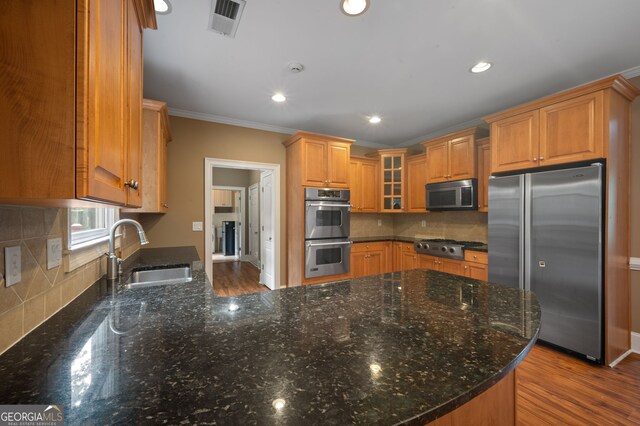 3725 Paces Park Cir SE, Smyrna, GA 30080 - kitchen featuring stainless steel appliances, a sink, glass insert cabinets, crown molding, and backsplash