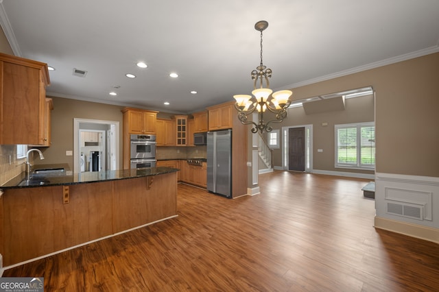 3725 Paces Park Cir SE, Smyrna, GA 30080 - kitchen featuring stainless steel appliances, ornamental molding, a peninsula, a sink, and a chandelier