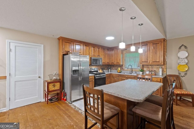 345 Jesse Martin Trl, Canton, GA 30115 - kitchen featuring appliances with stainless steel finishes, a sink, brown cabinetry, light countertops, and recessed lighting