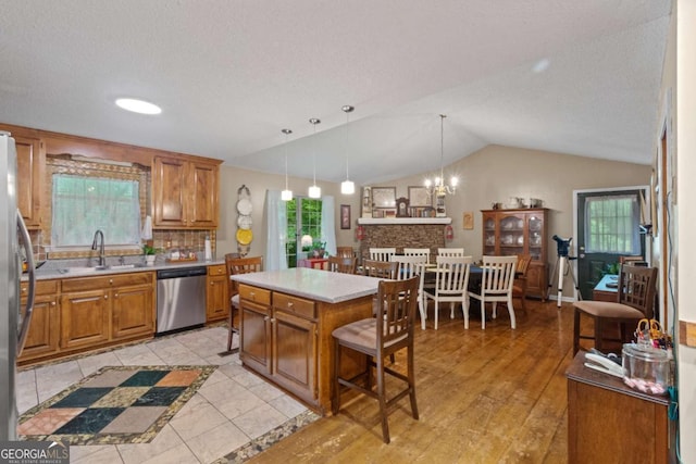 345 Jesse Martin Trl, Canton, GA 30115 - kitchen featuring stainless steel appliances, vaulted ceiling, brown cabinetry, and light countertops
