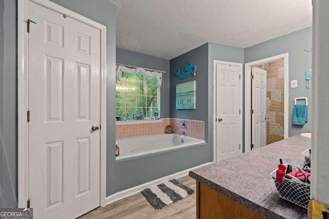 345 Jesse Martin Trl, Canton, GA 30115 - full bath featuring wood finished floors, a bath, and a textured ceiling