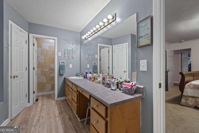 345 Jesse Martin Trl, Canton, GA 30115 - full bathroom featuring a textured ceiling, vanity, a tile shower, wood finished floors, and ensuite bath