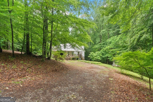 345 Jesse Martin Trl, Canton, GA 30115 - view of yard with a wooded view, dirt driveway, and stairs