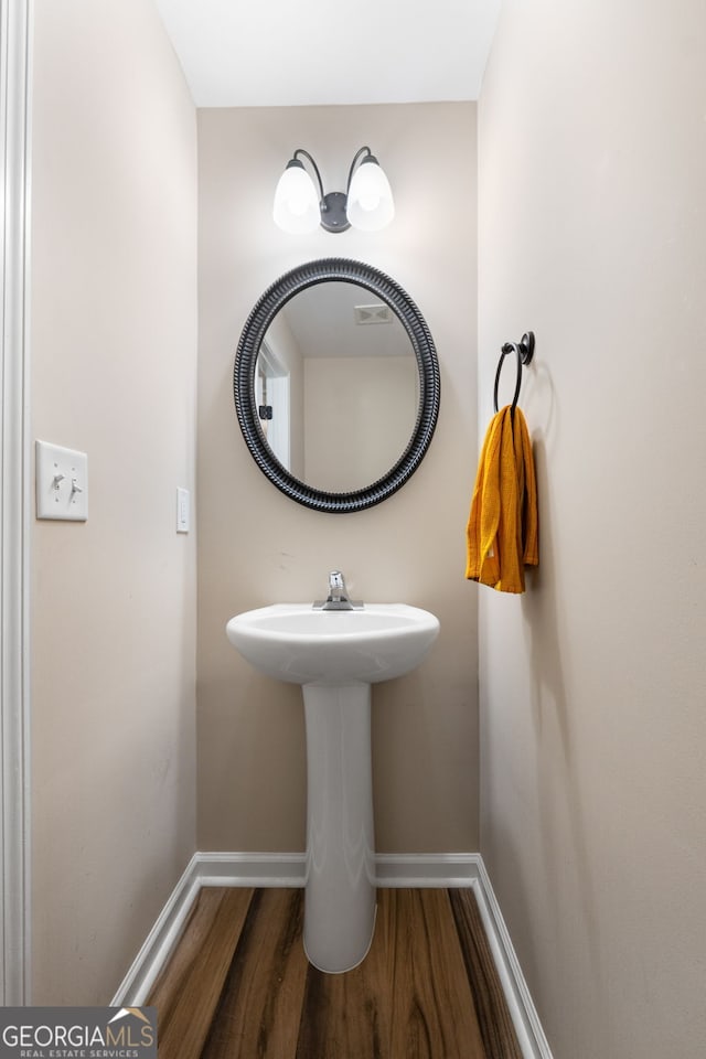 149 Pristine Dr, Locust Grove, GA 30248 - bathroom with wood finished floors and baseboards