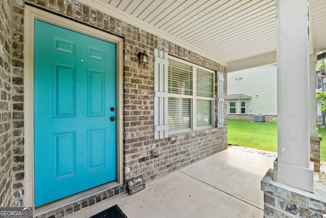 149 Pristine Dr, Locust Grove, GA 30248 - property entrance featuring a porch, brick siding, and a yard