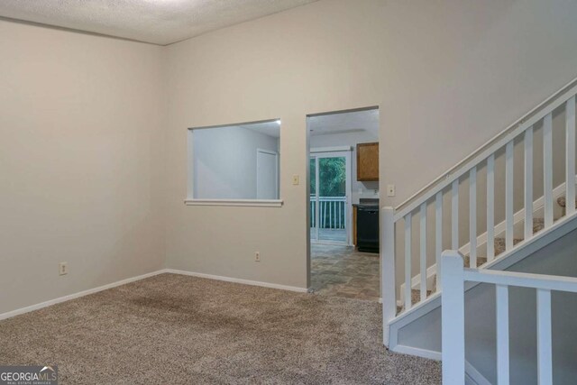 4634 Garden Hills Dr, Stone Mountain, GA 30083 - empty room featuring carpet, stairway, and a textured ceiling