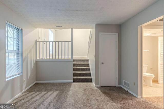 4634 Garden Hills Dr, Stone Mountain, GA 30083 - stairway with carpet floors and a textured ceiling