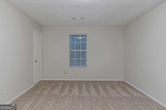 4634 Garden Hills Dr, Stone Mountain, GA 30083 - carpeted empty room featuring a textured ceiling and baseboards