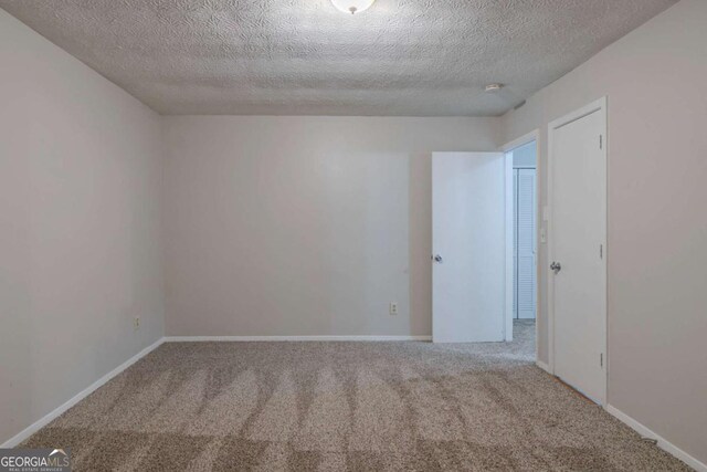 4634 Garden Hills Dr, Stone Mountain, GA 30083 - carpeted empty room with a textured ceiling and baseboards