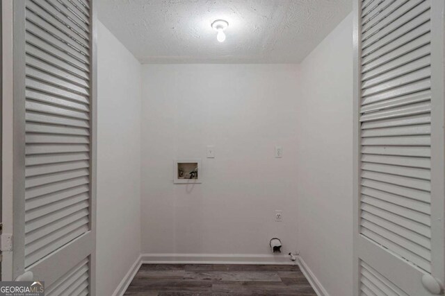 4634 Garden Hills Dr, Stone Mountain, GA 30083 - washroom with hookup for a washing machine, dark wood-type flooring, hookup for an electric dryer, and a textured ceiling