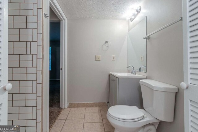 4634 Garden Hills Dr, Stone Mountain, GA 30083 - bathroom with a textured ceiling, vanity, and tile patterned flooring