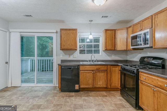 4634 Garden Hills Dr, Stone Mountain, GA 30083 - kitchen with black appliances, dark countertops, a textured ceiling, and brown cabinets