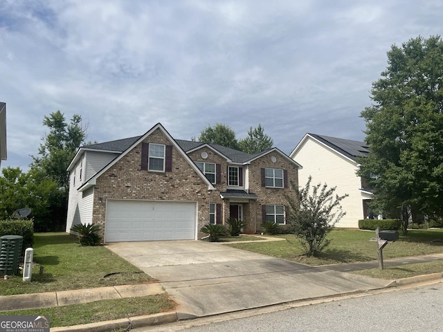 901 Broderick Cir, Warner Robins, GA 31088 - traditional-style house with driveway, a front lawn, brick siding, and an attached garage