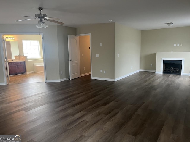 901 Broderick Cir, Warner Robins, GA 31088 - unfurnished living room featuring dark wood-style floors, a ceiling fan, baseboards, and a fireplace