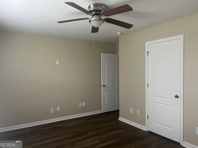 901 Broderick Cir, Warner Robins, GA 31088 - unfurnished bedroom with dark wood-style flooring, baseboards, and ceiling fan
