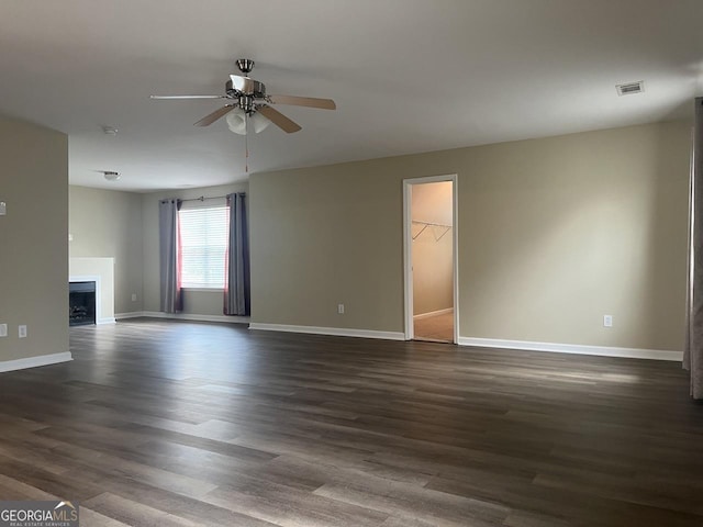 901 Broderick Cir, Warner Robins, GA 31088 - unfurnished living room with a ceiling fan, baseboards, and dark wood-type flooring
