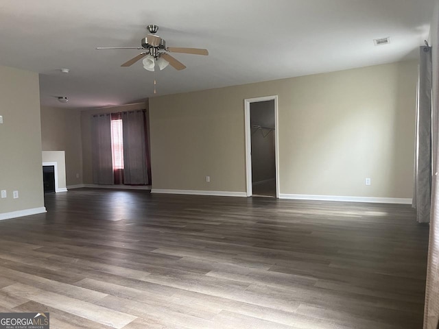 901 Broderick Cir, Warner Robins, GA 31088 - unfurnished living room with ceiling fan, baseboards, dark wood finished floors, and a fireplace