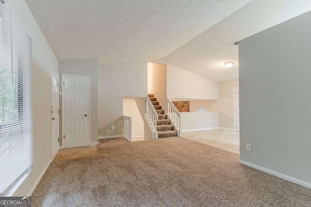 4905 Sandberg Ct, Stone Mountain, GA 30088 - interior space featuring carpet, a textured ceiling, baseboards, and lofted ceiling