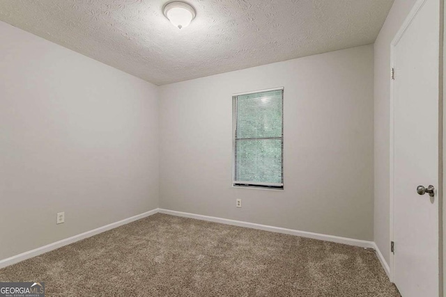 4905 Sandberg Ct, Stone Mountain, GA 30088 - spare room with carpet floors, baseboards, and a textured ceiling