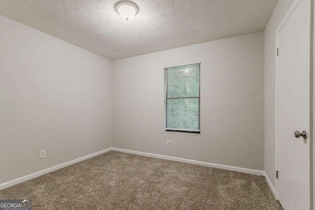 4905 Sandberg Ct, Stone Mountain, GA 30088 - empty room featuring carpet and a textured ceiling