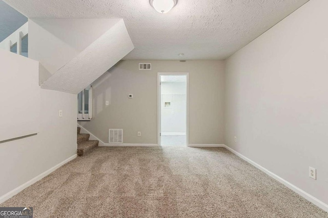 4905 Sandberg Ct, Stone Mountain, GA 30088 - additional living space with a textured ceiling, carpet, stairs, and baseboards