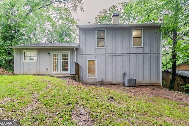 4905 Sandberg Ct, Stone Mountain, GA 30088 - rear view of house with a chimney, french doors, and a lawn