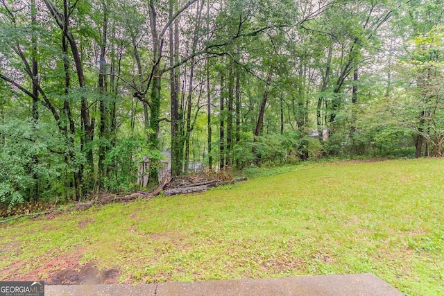 4905 Sandberg Ct, Stone Mountain, GA 30088 - view of grassy yard with a forest view