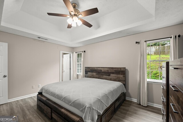 3208 Navajo Cir, Gainesville, GA 30501 - bedroom with a raised ceiling, wood finished floors, and a ceiling fan