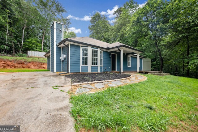 3208 Navajo Cir, Gainesville, GA 30501 - view of front of house with a chimney, a front lawn, and driveway