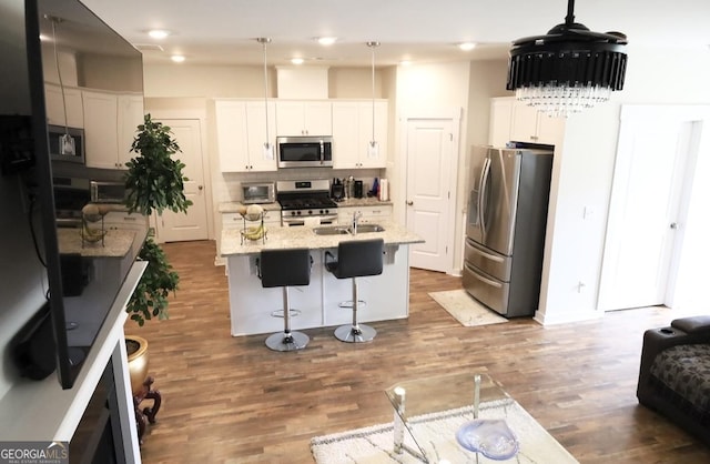 2845 Long Shadow Ct, Snellville, GA 30078 - kitchen with appliances with stainless steel finishes, a sink, a kitchen bar, backsplash, and white cabinetry