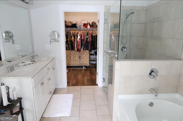 2845 Long Shadow Ct, Snellville, GA 30078 - full bath featuring a stall shower, double vanity, a spacious closet, a bath, and tile patterned floors