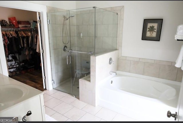 2845 Long Shadow Ct, Snellville, GA 30078 - bathroom featuring a bath, a shower stall, a walk in closet, and vanity