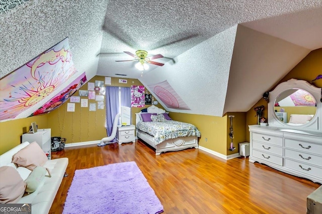 2200 E Lake Rd, Mcdonough, GA 30252 - bedroom featuring a textured ceiling, wood finished floors, ceiling fan, and vaulted ceiling