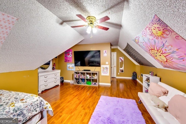 2200 E Lake Rd, Mcdonough, GA 30252 - bedroom with lofted ceiling, a textured ceiling, wood finished floors, and ceiling fan