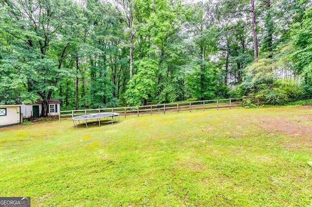 2200 E Lake Rd, Mcdonough, GA 30252 - fenced backyard with a trampoline and an outbuilding