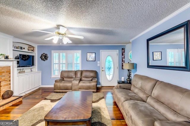 2200 E Lake Rd, Mcdonough, GA 30252 - living room featuring a textured ceiling, ornamental molding, dark wood-style flooring, a ceiling fan, and built in features
