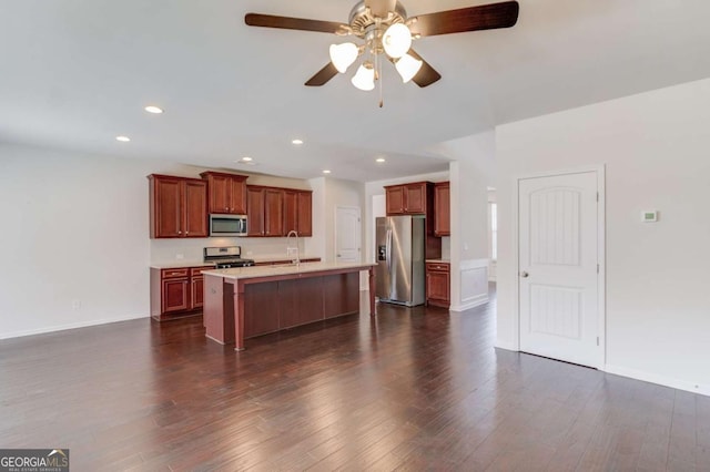 385 Broadmoor Dr, Braselton, GA 30517 - kitchen featuring appliances with stainless steel finishes, light countertops, ceiling fan, dark wood-type flooring, and an island with sink