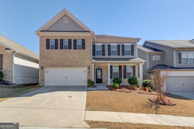 385 Broadmoor Dr, Braselton, GA 30517 - view of front of house with brick siding, driveway, a garage, and a porch