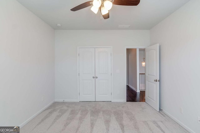 385 Broadmoor Dr, Braselton, GA 30517 - unfurnished bedroom featuring a closet, carpet, baseboards, and a ceiling fan
