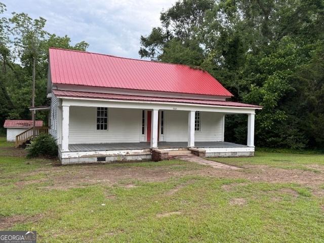 9610 Ga Highway 242, Harrison, GA 31035 - farmhouse with covered porch, a front lawn, crawl space, and metal roof