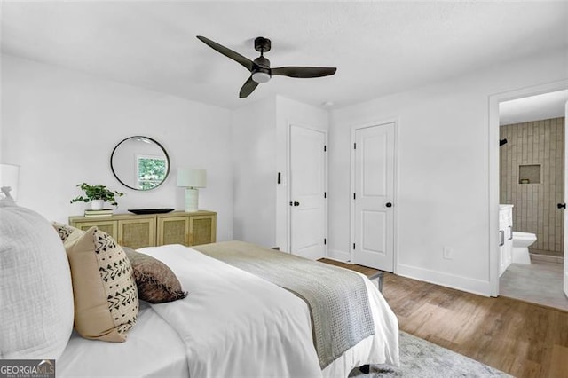 5666 Fawn Dr, Powder Springs, GA 30127 - bedroom featuring wood finished floors, ensuite bath, baseboards, and ceiling fan