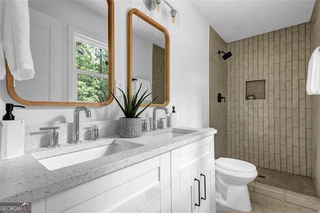 5666 Fawn Dr, Powder Springs, GA 30127 - full bathroom featuring double vanity, tiled shower, and toilet