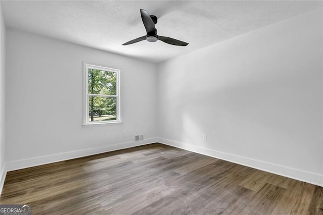 5666 Fawn Dr, Powder Springs, GA 30127 - empty room with wood finished floors, baseboards, a textured ceiling, and a ceiling fan