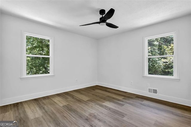 5666 Fawn Dr, Powder Springs, GA 30127 - unfurnished room featuring plenty of natural light, wood finished floors, and baseboards
