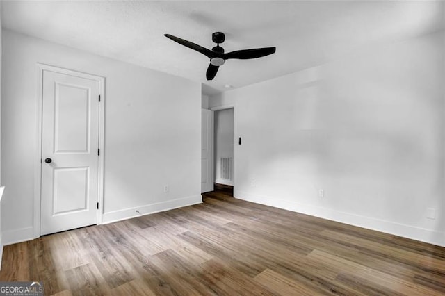5666 Fawn Dr, Powder Springs, GA 30127 - unfurnished bedroom featuring wood finished floors, baseboards, and a ceiling fan