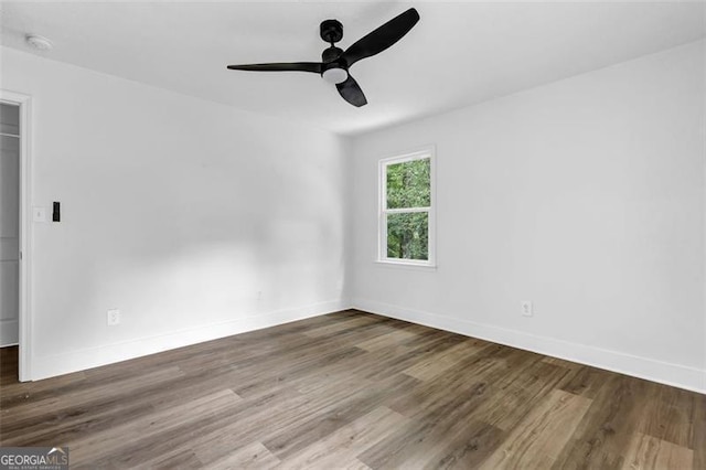 5666 Fawn Dr, Powder Springs, GA 30127 - spare room featuring baseboards, wood finished floors, a ceiling fan, and a smoke detector