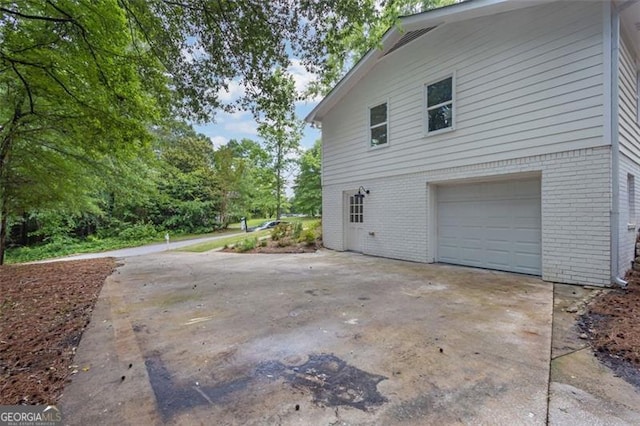 5666 Fawn Dr, Powder Springs, GA 30127 - view of side of property with brick siding, an attached garage, and driveway