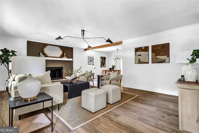 5666 Fawn Dr, Powder Springs, GA 30127 - living area with wood finished floors, baseboards, and a brick fireplace