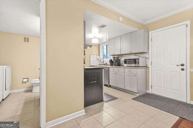 2952 N Dekalb Dr Unit C, Atlanta, GA 30340 - kitchen with washer and clothes dryer, light tile patterned floors, appliances with stainless steel finishes, and ornamental molding