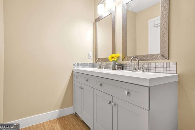 2952 N Dekalb Dr Unit C, Atlanta, GA 30340 - bathroom with double vanity, tasteful backsplash, and wood finished floors